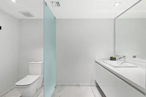 a bathroom with a sink a toilet and a mirror