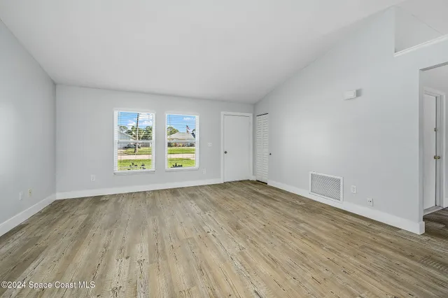 wooden floor in an empty room with a window