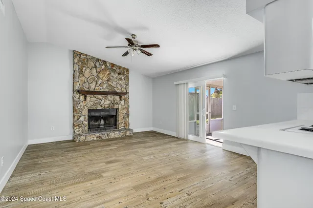 a view of empty room with a fireplace