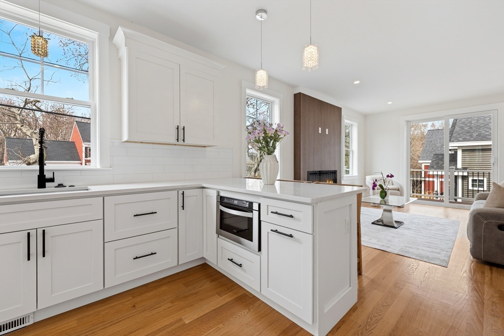 2 Old County Road, Unit 14 Salisbury, MA 01952 - Photo 8 of 33 a kitchen with stainless steel appliances white cabinets and wooden floors