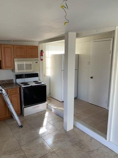 2830 Northeast 7th Terrace Pompano Beach, FL 33064 - Photo 6 of 11 a view of kitchen with refrigerator stove and microwave