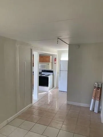 a view of an empty room with a fireplace