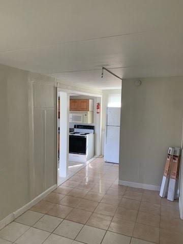 2830 Northeast 7th Terrace Pompano Beach, FL 33064 - Photo 7 of 11 a view of an empty room with a fireplace