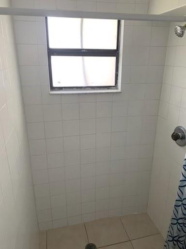 2830 Northeast 7th Terrace Pompano Beach, FL 33064 - Photo 8 of 11 a bathroom with a window