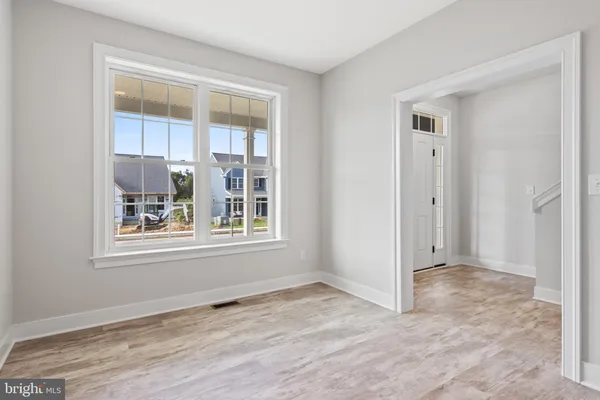 a view of an empty room with a window and fireplace