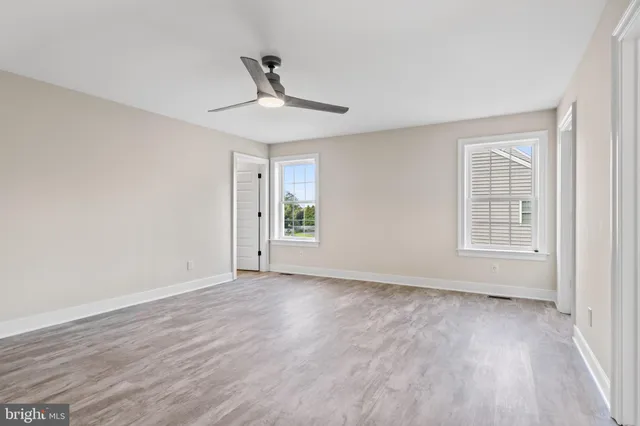 a bathroom with a toilet a sink and a window