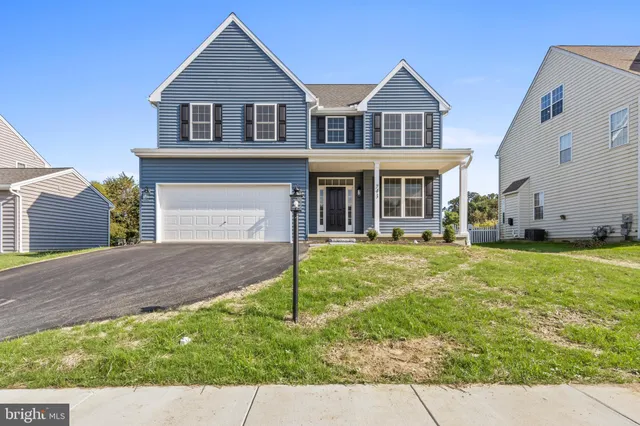 a view of a hallway with wooden floor and entryway