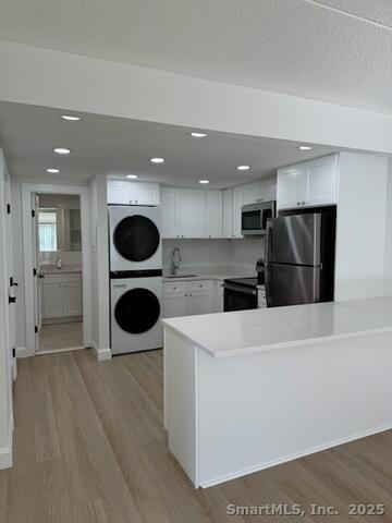 38 B Putnam Green, Unit L Greenwich, CT 06830 - Photo 2 of 15 a view of a kitchen with a sink and refrigerator