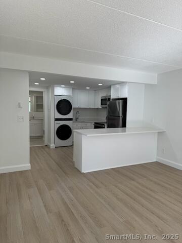 38 B Putnam Green, Unit L Greenwich, CT 06830 - Photo 4 of 15 a view of a kitchen with a sink and a microwave