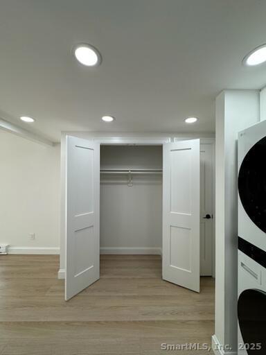 38 B Putnam Green, Unit L Greenwich, CT 06830 - Photo 5 of 15 a view of an empty room with wooden floor and cabinet