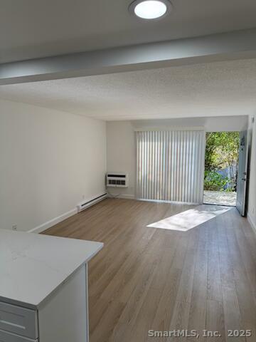 38 B Putnam Green, Unit L Greenwich, CT 06830 - Photo 9 of 15 a view of an empty room with wooden floor and a window