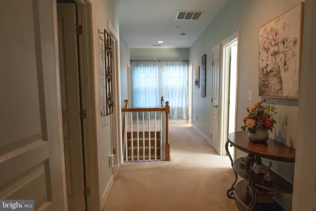 a bedroom with a bed and a mirror on dresser