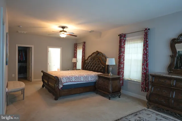 a bedroom with a bed dresser and window