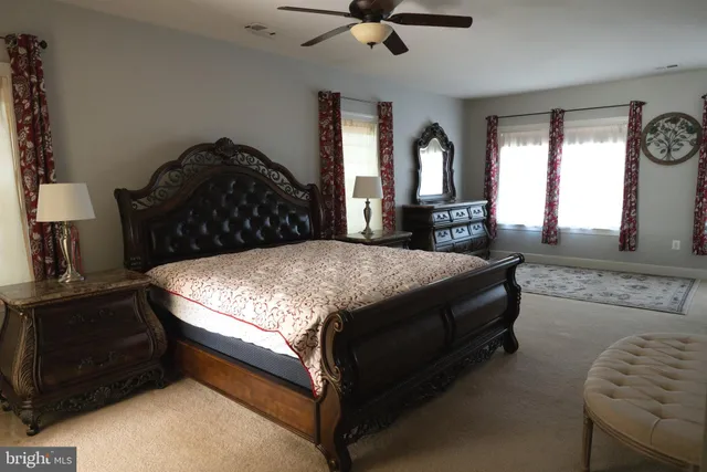 a bathroom with a bathtub a sink and a large mirror