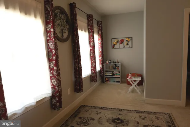 a view of walk in closet with clothes