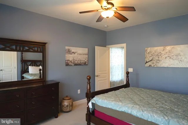 a bedroom with a bed and a painting on the wall
