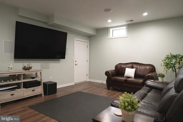 a living room with furniture a fireplace and a floor to ceiling window