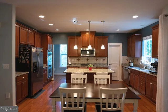 a large kitchen with a table and chairs