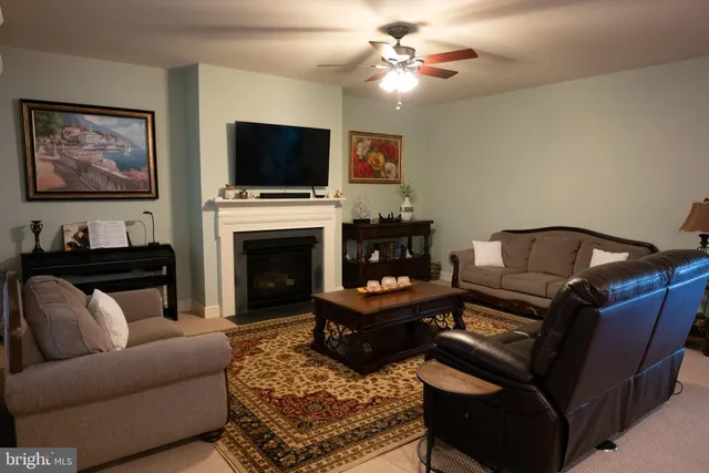 a living room with furniture and a bookshelf
