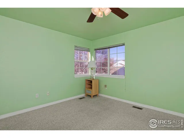 a view of empty room with fan and window