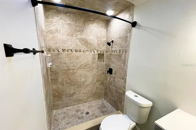 a bathroom with a shower toilet and sink