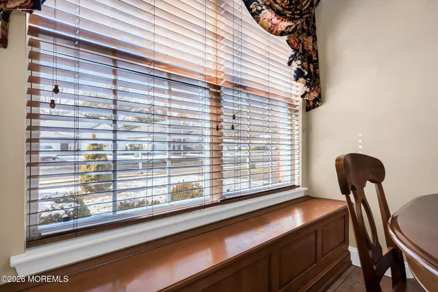 a living room with furniture a dining table and a chandelier