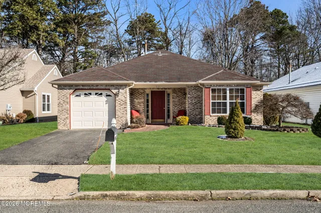 a front view of a house with a yard and porch