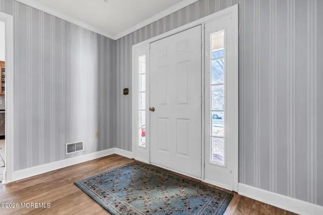 a kitchen with stainless steel appliances granite countertop a stove top oven a sink and a refrigerator