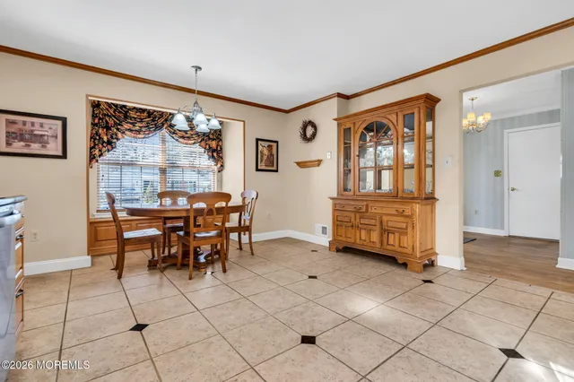 a kitchen with a table chairs and a refrigerator