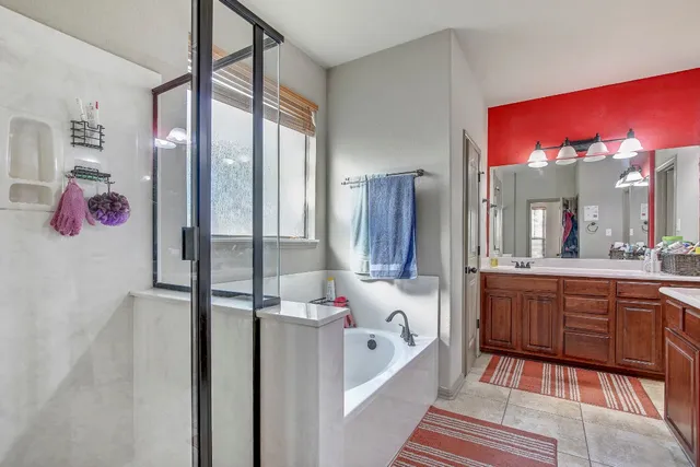 a white bath tub sitting next to a shower