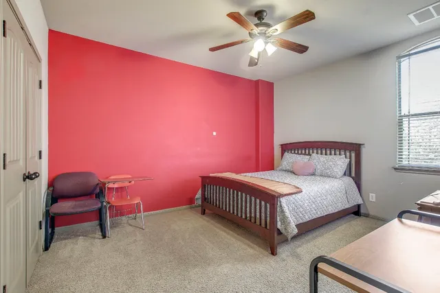 a bedroom with a bed and a chandelier