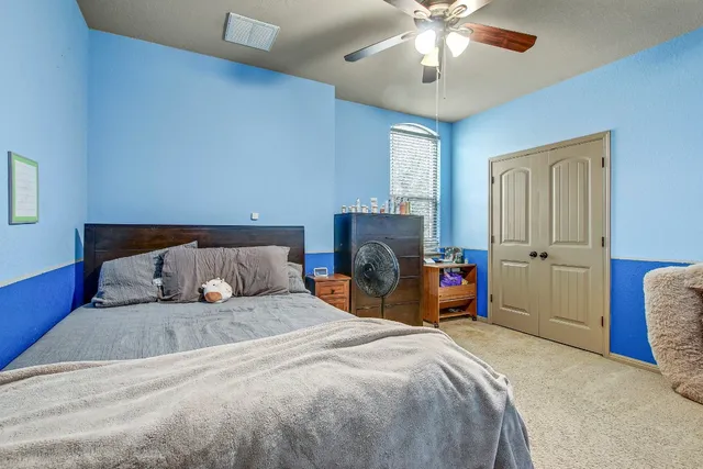 a bedroom with a bed and a chandelier