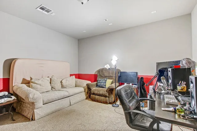 a view of an empty room with a fireplace and a window