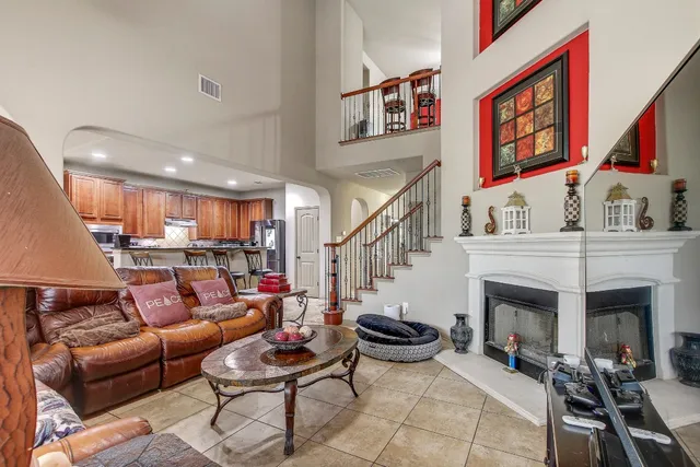a living room with furniture kitchen view and a fireplace