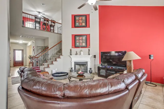 a living room with fireplace furniture and a flat screen tv
