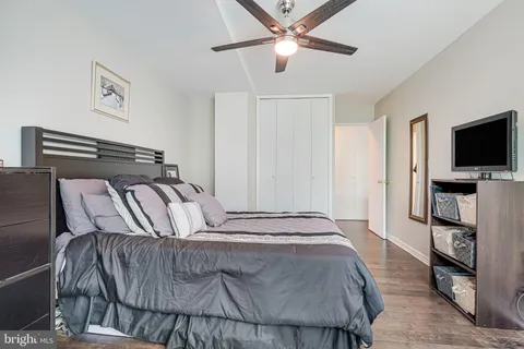 a bedroom with a large bed and a flat screen tv