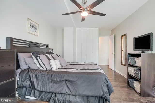 a bedroom with a large bed and a flat screen tv