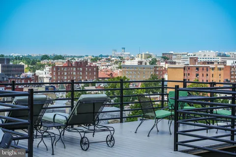 a view of a chairs and table in a balcony