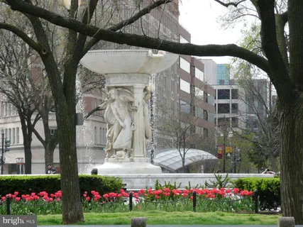 a front view of a building with cars