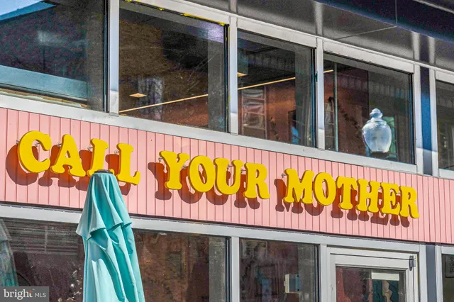 an outdoor seating with a umbrella and trees