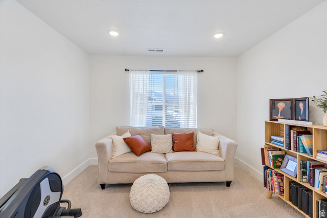 2664 West Maple Street Mapleton, UT 84664 - Photo 20 of 49 Versatile room featuring recessed lighting, a window with blinds and sheer curtains, light-colored carpeting, white baseboards, and a light wood-finish bookshelf