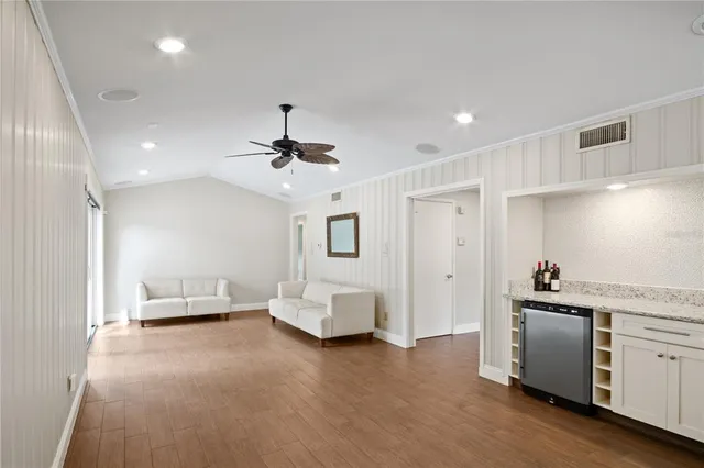 a living room with furniture and white walls