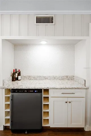 a kitchen with granite countertop white cabinets and white appliances