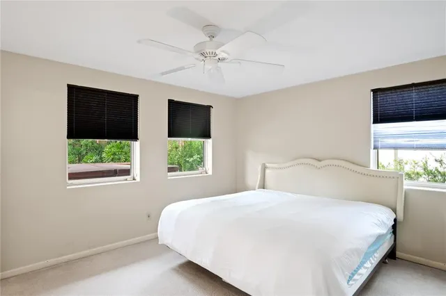 a bedroom with a large bed and a window