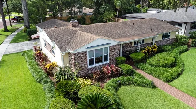an aerial view of house with yard and outdoor seating