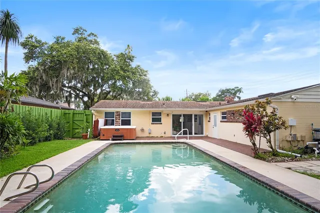 a view of house with swimming pool yard and outdoor seating