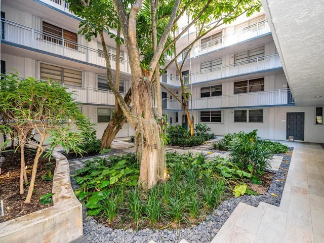 a front view of a building with garden