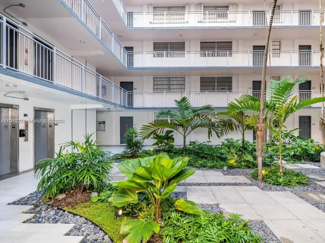 a view of a multi story building with a yard