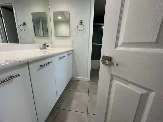 a bathroom with a double vanity sink and mirror