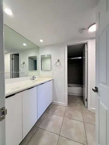 a spacious bathroom with a granite countertop sink mirror and